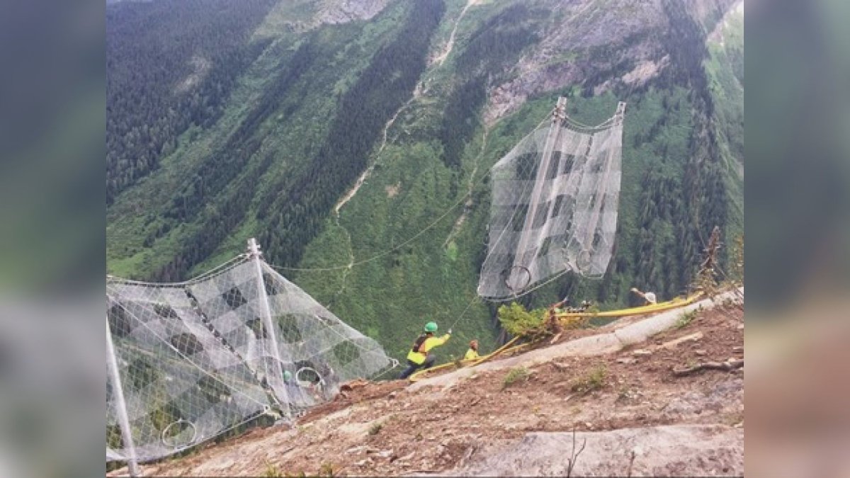 Parks Canada avalanche specialists prepare to install snow nets high above the Trans-Canada Highway in Rogers Pass. 
