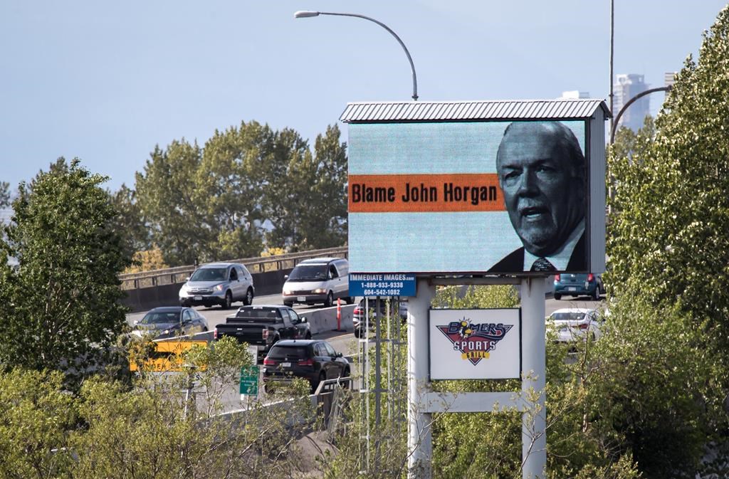 Motorists travel over the Alex Fraser Bridge as an electronic billboard paid for by the B.C. Liberal caucus, placing blame for high gas prices on Premier John Horgan is seen in Delta, B.C., on Saturday May 4, 2019. 