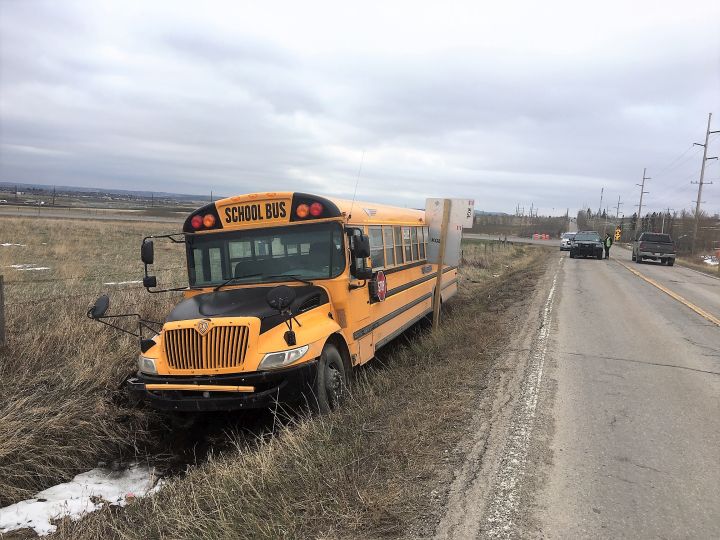 A school bus sits in a ditch on the side of the road in the area of 162 Avenue S.W. and 37 Street S.W. on Thursday, May 2, 2019.