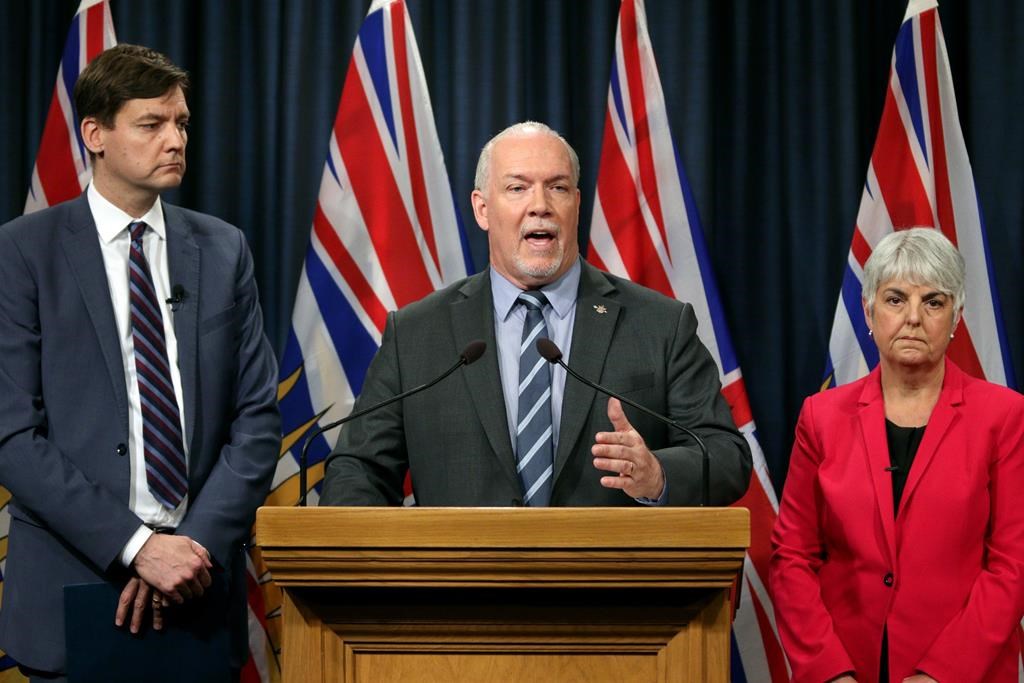 Premier John Horgan is joined by Finance Minister Carole James and Attorney General David Eby as they announce a decision to move forward with the public inquiry in light of recent findings on money laundering in the province during a press conference at Legislature in Victoria, B.C., on Wednesday, May 15, 2019. THE CANADIAN PRESS/Chad Hipolito.