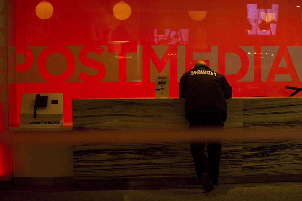 A security guard stands by the front reception desk at Postmedia's Toronto headquarters on Monday, March 12, 2018.