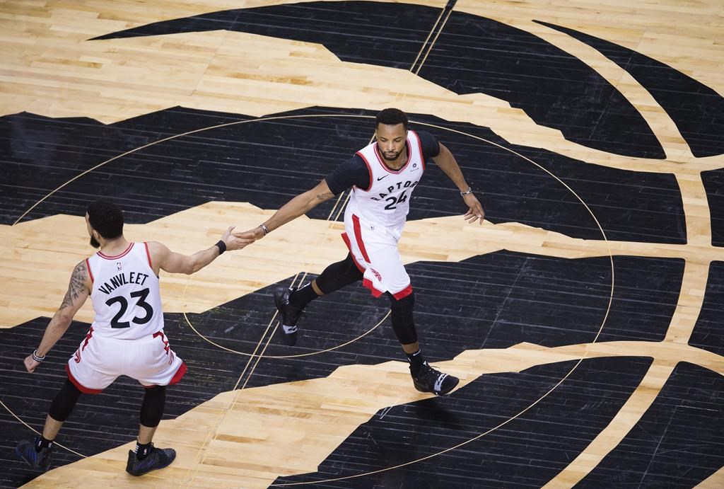 Toronto Raptors forward Norman Powell (24) celebrates his basket with teammate Fred VanVleet (23) while playing against the Milwaukee Bucks during second half NBA Eastern Conference finals basketball action in Toronto on Tuesday, May 21, 2019. THE CANADIAN PRESS/Nathan Denette