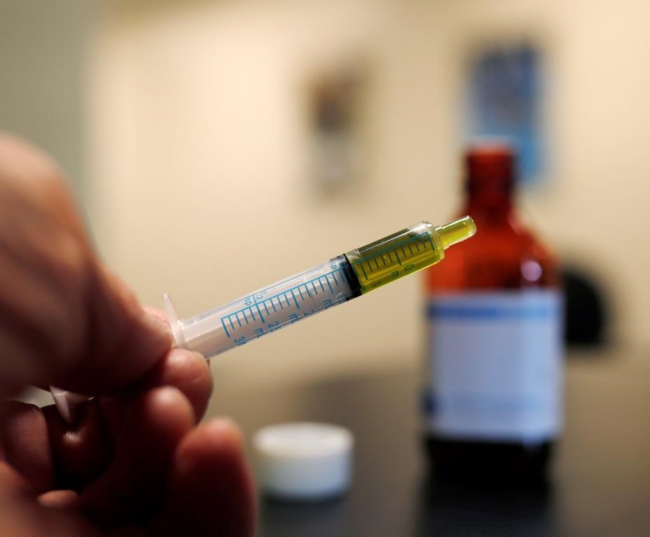 A syringe loaded with a dose of CBD oil is shown in a research laboratory at Colorado State University in Fort Collins, Colo., on November 6, 2017.