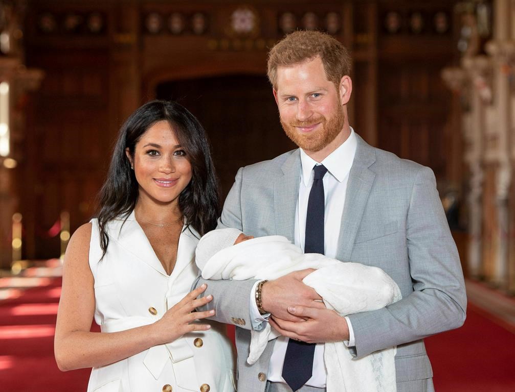 Prince Harry and Meghan, Duke and Duchess of Sussex, posed during a photocall with their newborn son, Archie Harrison, in St. George’s Hall on May 8, 2019.