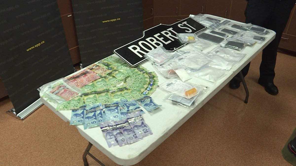 Drugs, cash and even a street sign were among the items seized at two residences in Napanee, according to Lennox and Addington OPP.