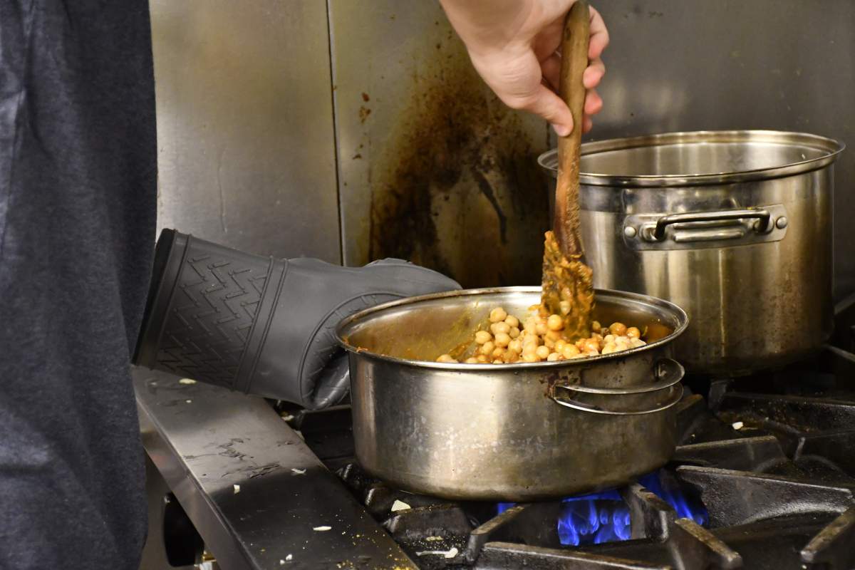 A student in Toronto’s PACTCooking program makes chickpea curry.
