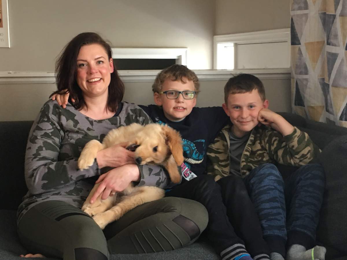Eight-year-old Emery Spanik (centre), is beginning his healing journey with help fro puppy Hazel, older brother Griffin, and mother Georgia. They’re seen here in their Halifax home on May 17, 2019.