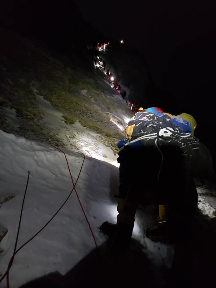 Climbers lined up at the narrow first step of the final push to the Everest summit before dawn.