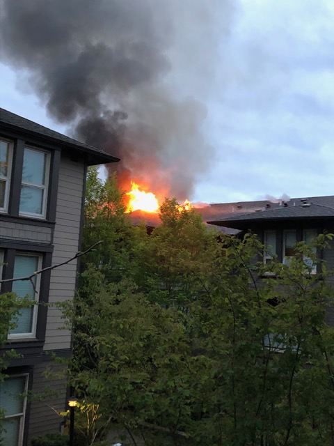 Flames seen shooting out of the top of a third-floor suite at a North Vancouver apartment building early Sunday, May 5, 2019.