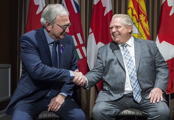 Ontario Premier Doug Ford, right, shakes hands with New Brunswick Premier Blaine Higgs during a meeting of Canada's premiers in Montreal, Thursday, December 6, 2018. 