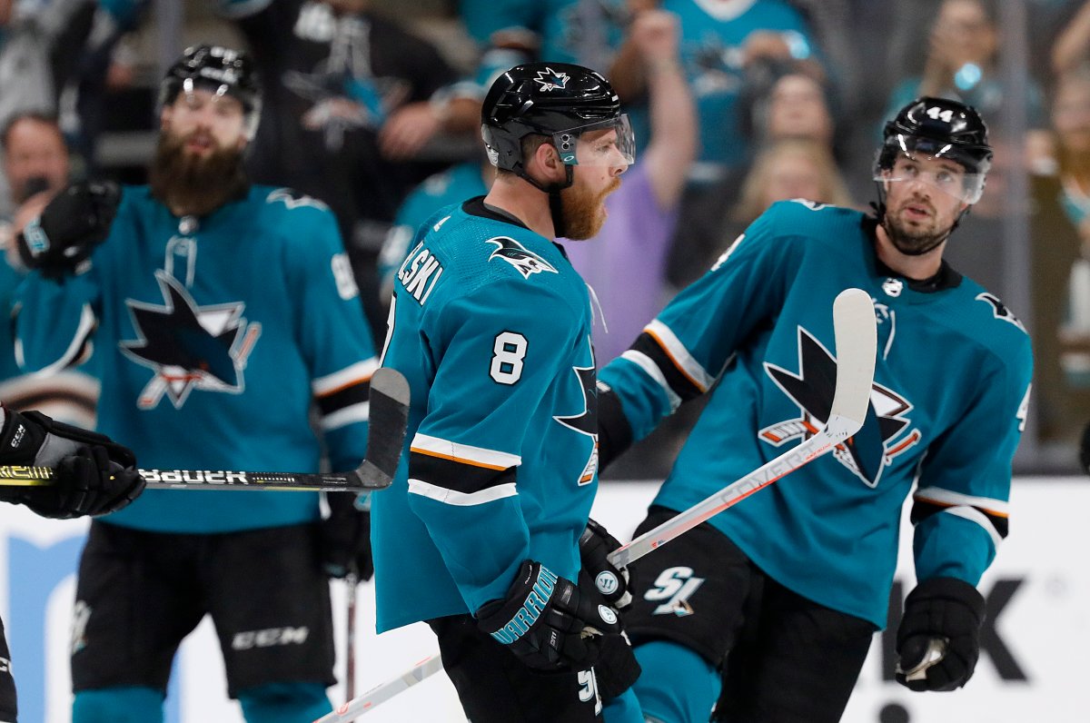 San Jose Sharks center Joe Pavelski (8) celebrates with teammates after the Sharks defeated the Colorado Avalanche in Game 7 of an NHL hockey second-round playoff series in San Jose, Calif., Wednesday, May 8, 2019. (AP Photo/Josie Lepe).
