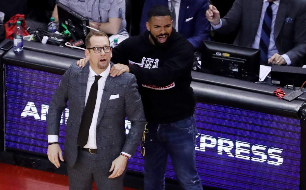 Drake massages Toronto Raptors head coach Nick Nurse’s shoulders as the Toronto Raptors beat the Milwaukee Bucks 120-102 in Game 4 to even up the Eastern Conference NBA Final at two games each at Scotiabank Arena in Toronto on May 21, 2019.