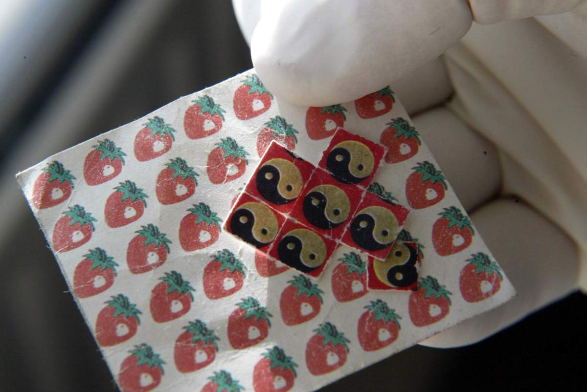 Drugs and drug-taking equipment – a sheet of LSD tabs.