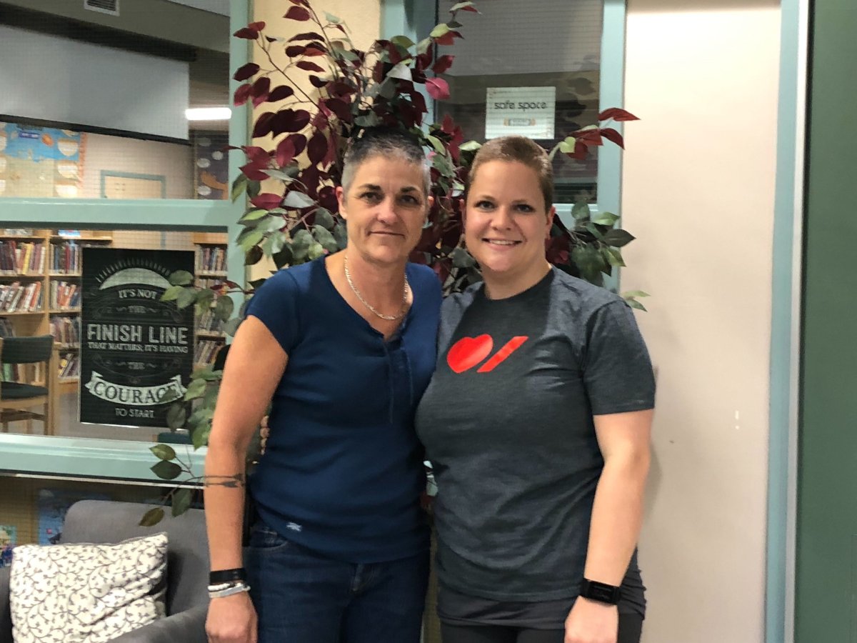 Grade 3 teacher Katie Osborne (right) and educational assistant Kim Jenkinson (left) both went under the clippers during a live video assembly for the entire school to watch.