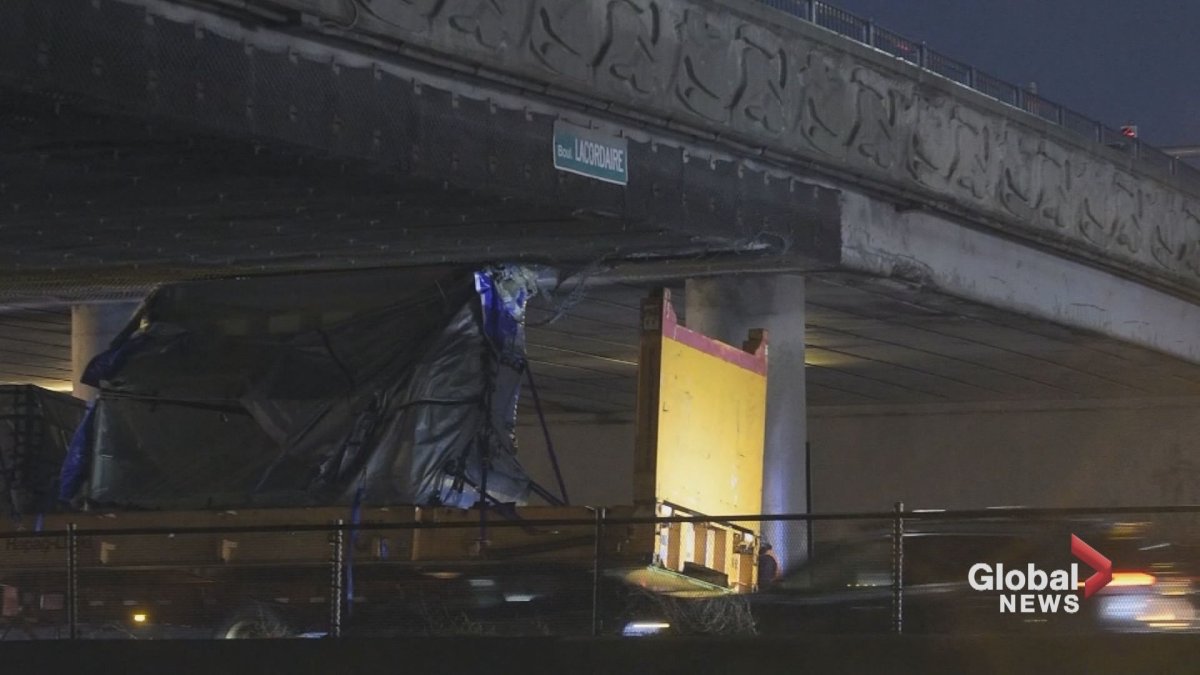 A semi-truck carrying heavy equipment struck the bottom of Lacordaire overpass on Autoroute 40.