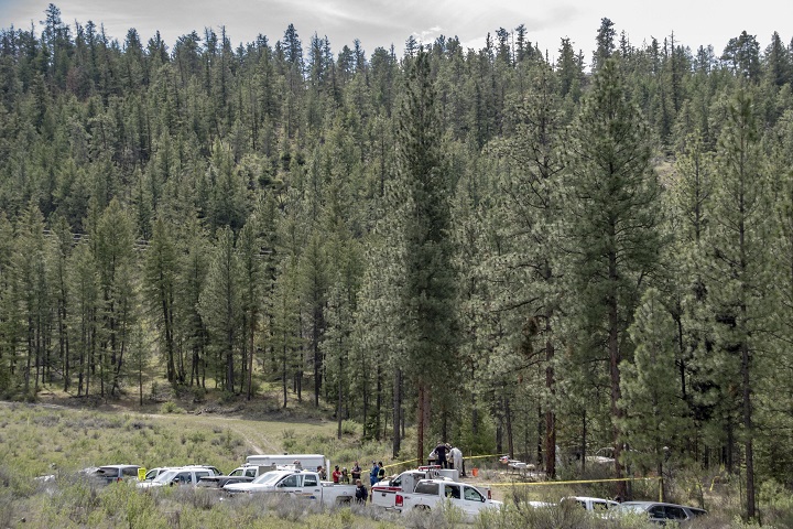 A vehicle is surrounded by police tape after human remains were found inside a recently burned truck east of Oliver, B.C.  