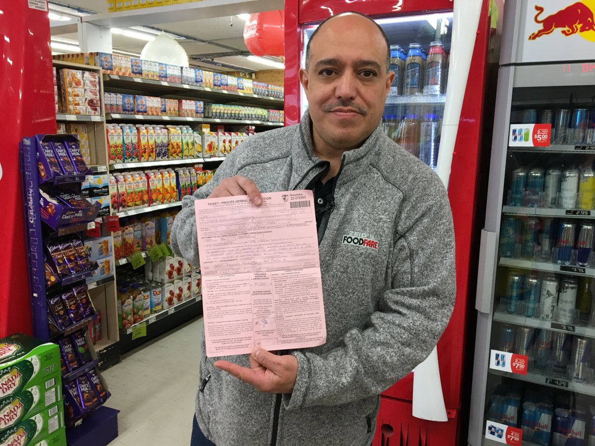 Munther Zeid with his $10,000 ticket for opening one of his grocery stores on Good Friday.