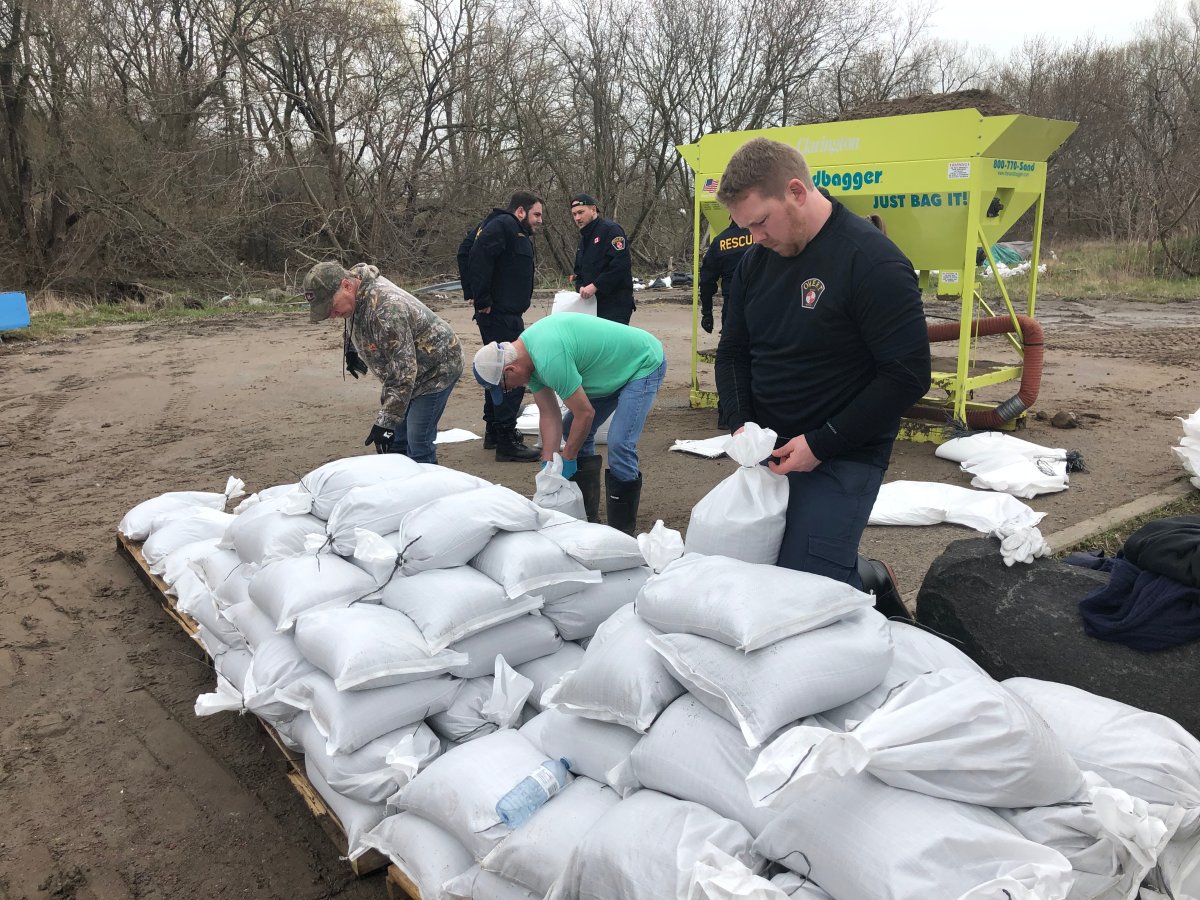 Residents in the municipality of Clarington fill sandbags to help prevent inundation from floodwaters from Lake Ontario.