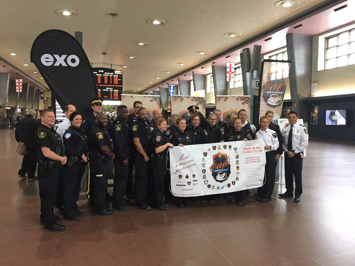 Officers from Montreal’s police department promote the Coffee with a Cop campaign.