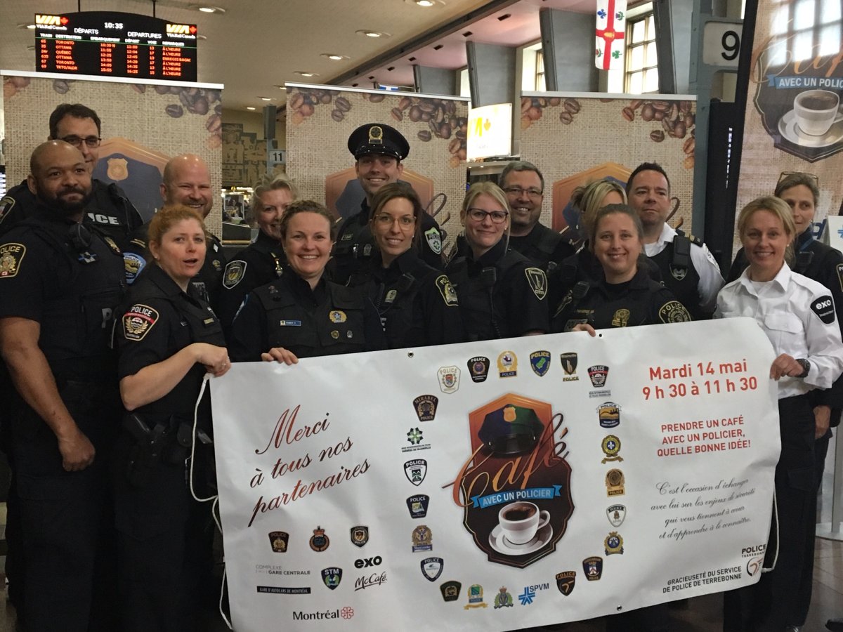 Officers from Montreal's police department promote the Coffee with a Cop campaign.