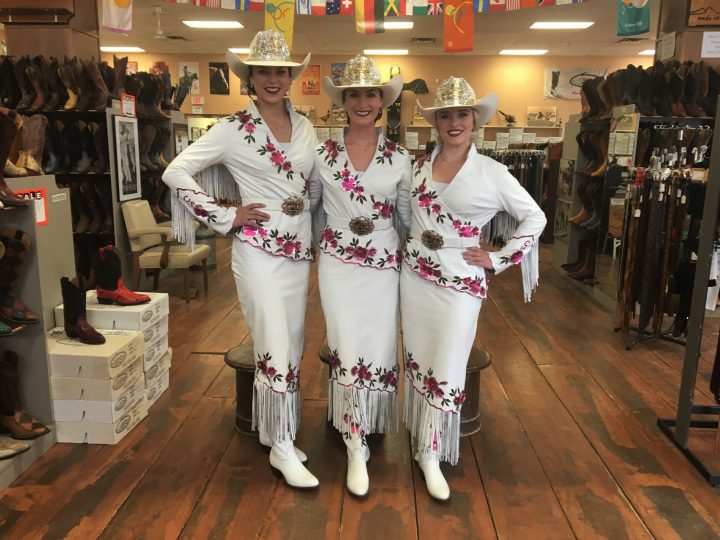 This year's Stampede Queen Carly Heath (centre) and Princesses Keily Stewart (left) and Courtney Dingreville (right) picked up their outfits on Monday.