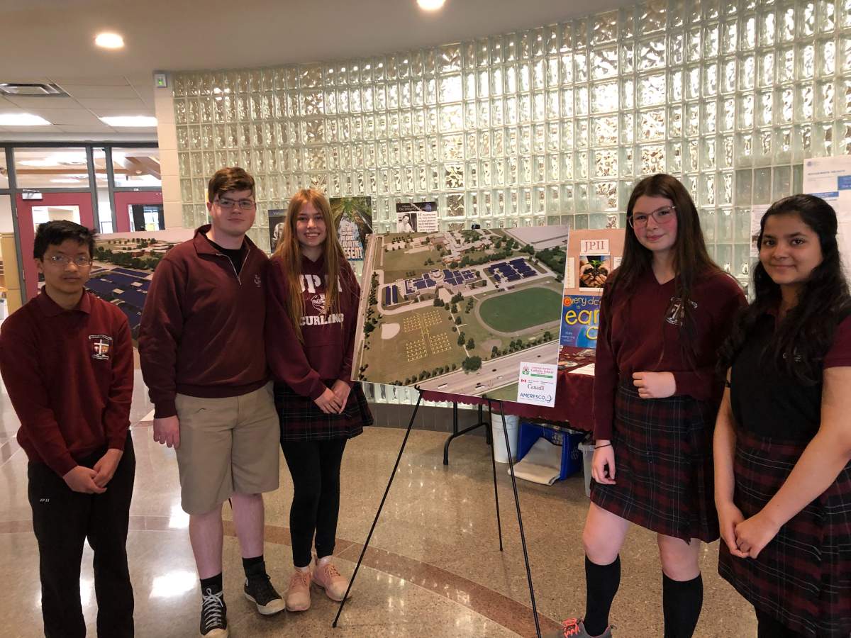 Students from John Paul II Catholic Secondary School stand near digital renderings of the school’s carbon neutral plans. From left to right: Zach Caadorna, Lewis Roseberry, Sarah Bedor, Desiree Prudhomme and Ievana Joseph-Philip.