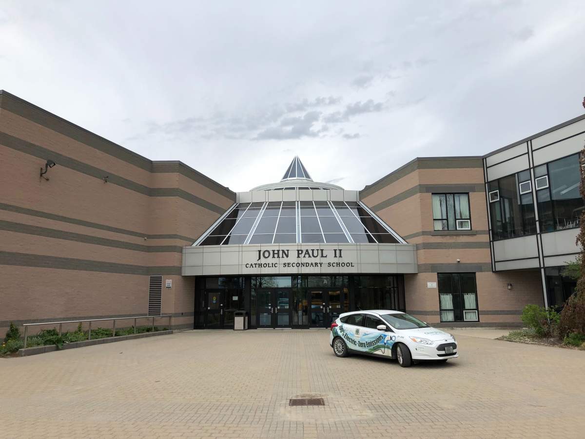 An electric vehicle sits parked outside John Paul II Catholic Secondary School in east London.