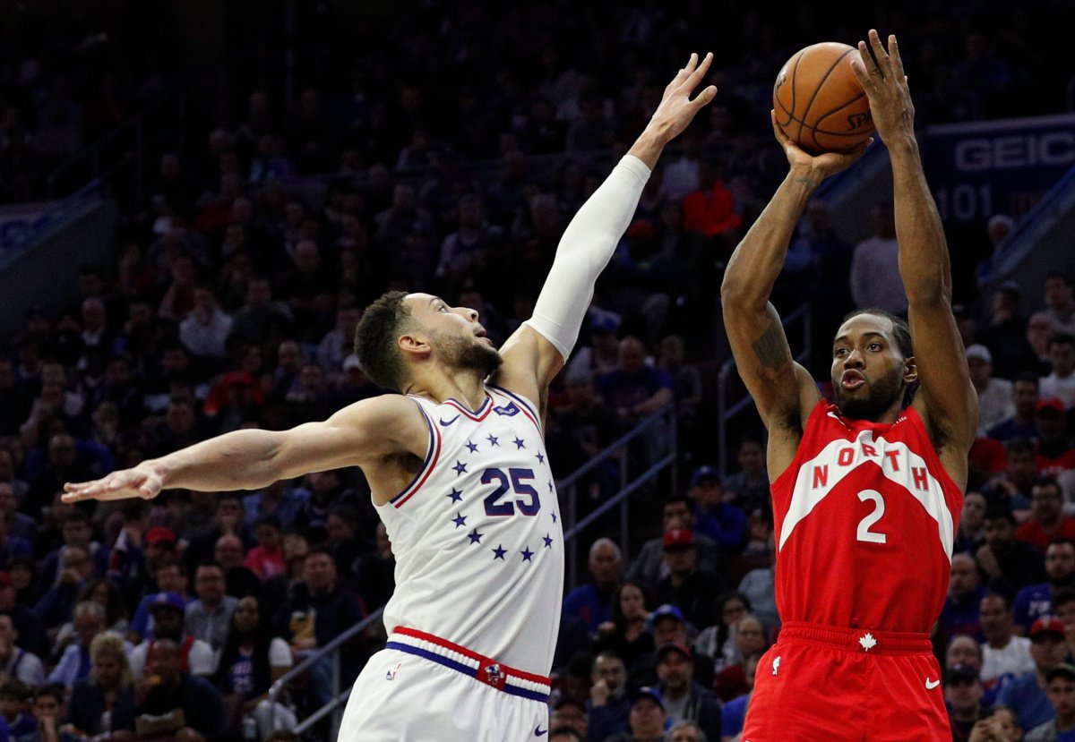 Toronto Raptors' Kawhi Leonard, right, shoots as Philadelphia 76ers' Ben Simmons, left, defends during the second half of Game 4 of their second-round NBA playoff series, Sunday, May 5, 2019, in Philadelphia.