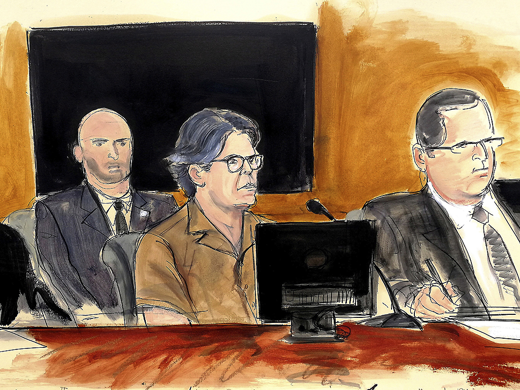 In this April 13, 2018 courtroom sketch, Keith Raniere, center, leader of NXIVM, attends a hearing at court in the Brooklyn borough of New York. 