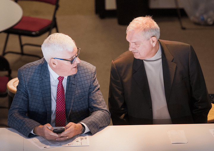 Kelowna Rockets president and general manager Bruce Hamilton, left, and assistant general manager Lorne Frey talk during a Rockets home game at Prospera Place. On Thursday, Kelowna added four players via trades.