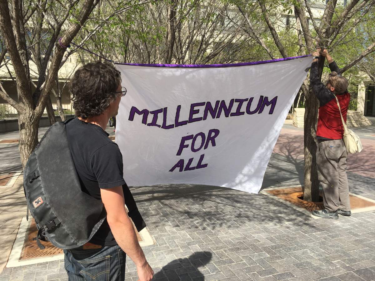 Demonstrators with the group “Millennium for All” want the city to stop security checks on patrons of the Millennium Library.