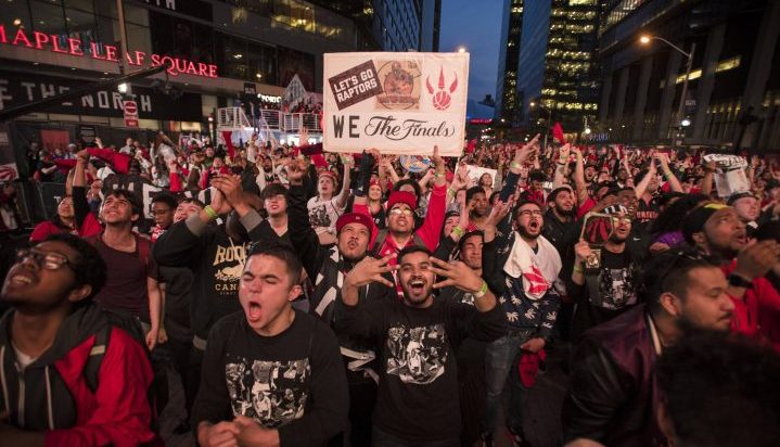 Toronto Raptors fans react in "Jurassic Park," outside the Scotiabank Arena after their team gets their first basket during game one NBA action against the Golden State Warriors in Toronto on Thursday, May 30, 2019.
