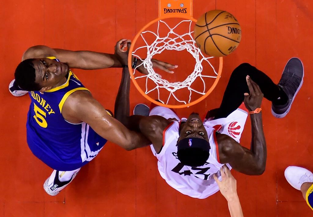 Toronto Raptors forward Pascal Siakam (43) eyes the ball against Golden State Warriors centre Kevon Looney (5) during second half NBA championship basketball finals action in Toronto on Thursday, May 30, 2019. THE CANADIAN PRESS/Nathan Denette.