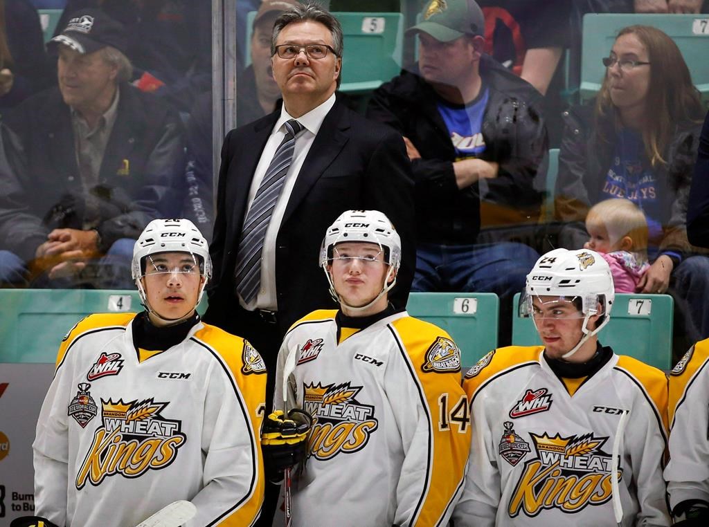 FILE – In this May 21, 2016, file photo, Brandon Wheat Kings head coach Kelly McCrimmon, top center, looks to the scoreboard with his players.
