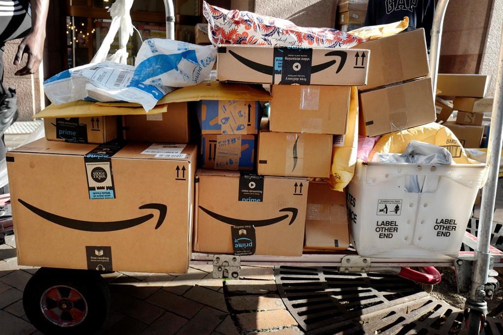 FILE - In this Oct. 10, 2018, file photo Amazon Prime boxes are loaded on a cart for delivery in New York.