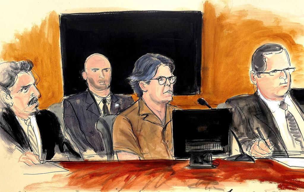 In this April 13, 2018 courtroom sketch Keith Raniere, second from right, leader of the secretive group NXIVM, attends a hearing at court in the Brooklyn borough of New York.