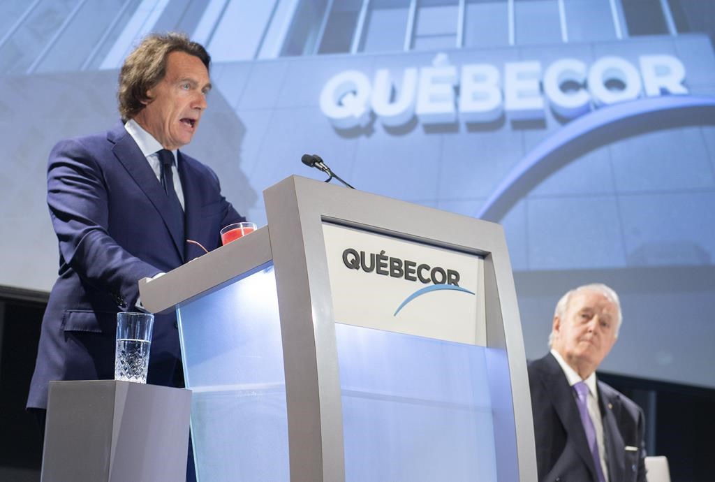 Quebecor president and CEO Pierre Karl Peladeau addresses the media company's annual meeting as the chairman of the board Brian Mulroney looks on in Montreal on Thursday, May 9, 2019.