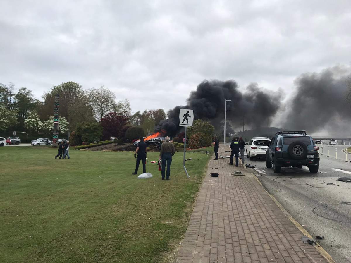 Officers escort a man away from the scene of the collision at the Peace Arch border crossing.