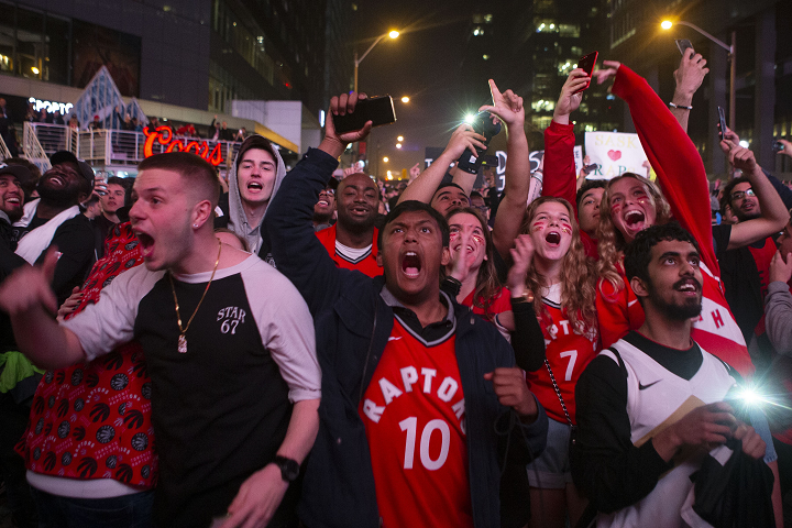 Toronto Raptors fans celebrate in the closing seconds of the team's 100-94 win over the Milwaukee Bucks to take the NBA Eastern Conference Championship, in Toronto on Saturday, May 25, 2019. The Raptors go to the NBA final for the first time in the franchise's history.