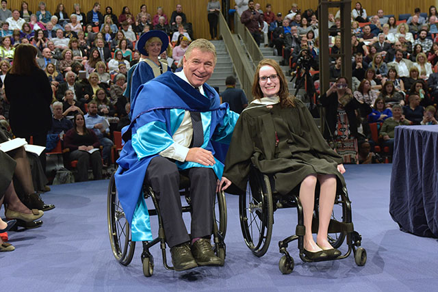 Valedictorian Casey Perrin (right) seen with former Canadian Paralympic athlete and activist Rick Hansen (left).