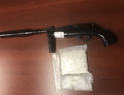Police say they seized a large quantity of methamphetamine pills, drug paraphernalia and a loaded sawed-off .22 calibre rifle. 