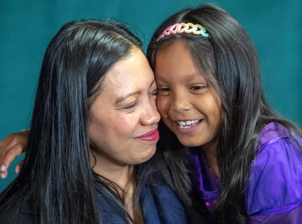Vanessa Rodel embraces her daughter Keana, 7, at a news conference Wednesday, May 29, 2019 in Montreal. Rodel played a key role in whistleblower Edward Snowden's escape from U.S. authorities in Hong Kong. THE CANADIAN PRESS/Ryan Remiorz.
