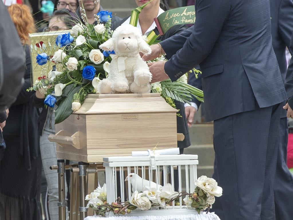 The casket of a seven-year-old girl who was found in critical condition inside of a home and later died is carried from the church after funeral services, Thursday, May 9, 2019 in Granby, Que.