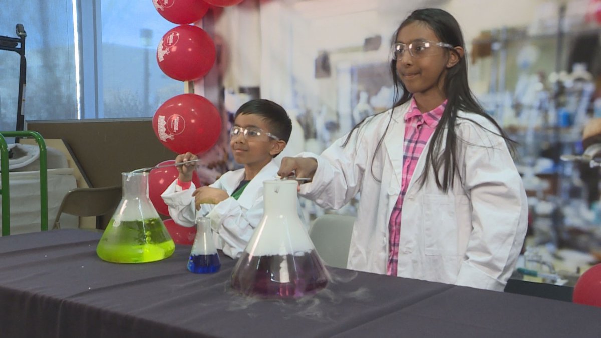 Two aspiring scientist pose at the 'Science Rendezvous' photo booth at the University of Manitoba.