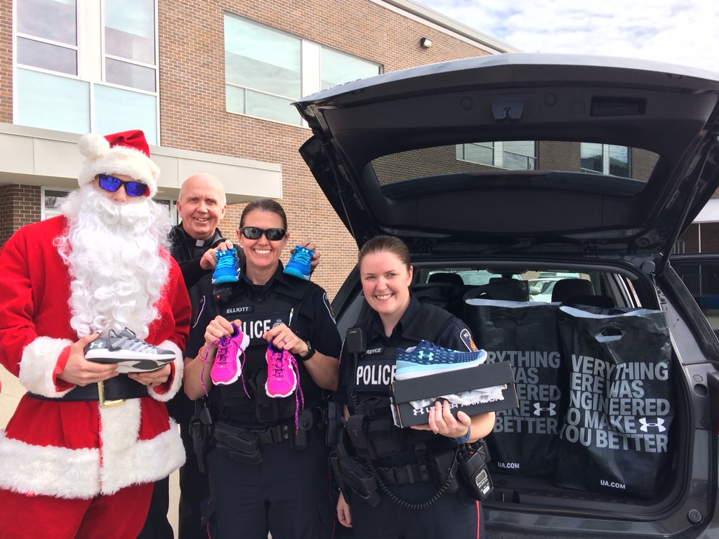 Santa (Const. Evan Harrison), Father Jim Mockler from St. Peter’s Cathedral, Const. Rebecca Elliot and Const. Anthea Fordyce filled a vehicle with shoes to be distributed to kids at schools across London.
