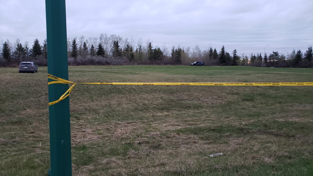 Edmonton police officers taped off a large part of a field on the city's northwestern outskirts Wednesday night. May 15, 2019. 
