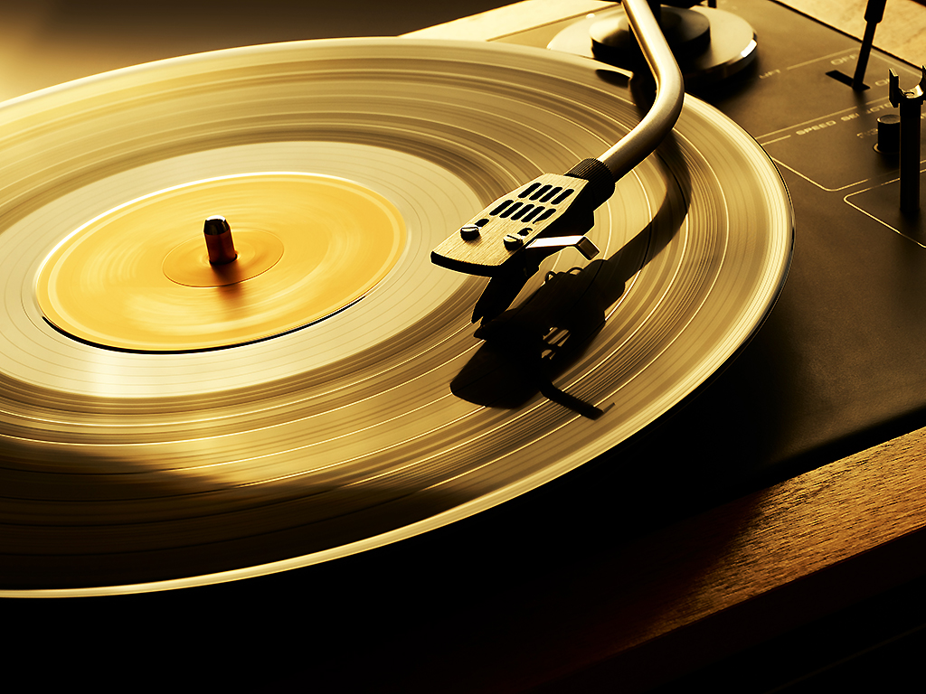 A vinyl record plays on a turntable.