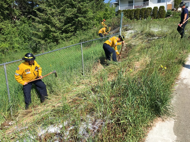 Members of West Kelowna Fire Rescue tackle a small grass fire along Deer Ridge Court in West Kelowna. Fire crews suspect carelessness started the fire and issued a reminder to be careful in the back country and in grassy areas.