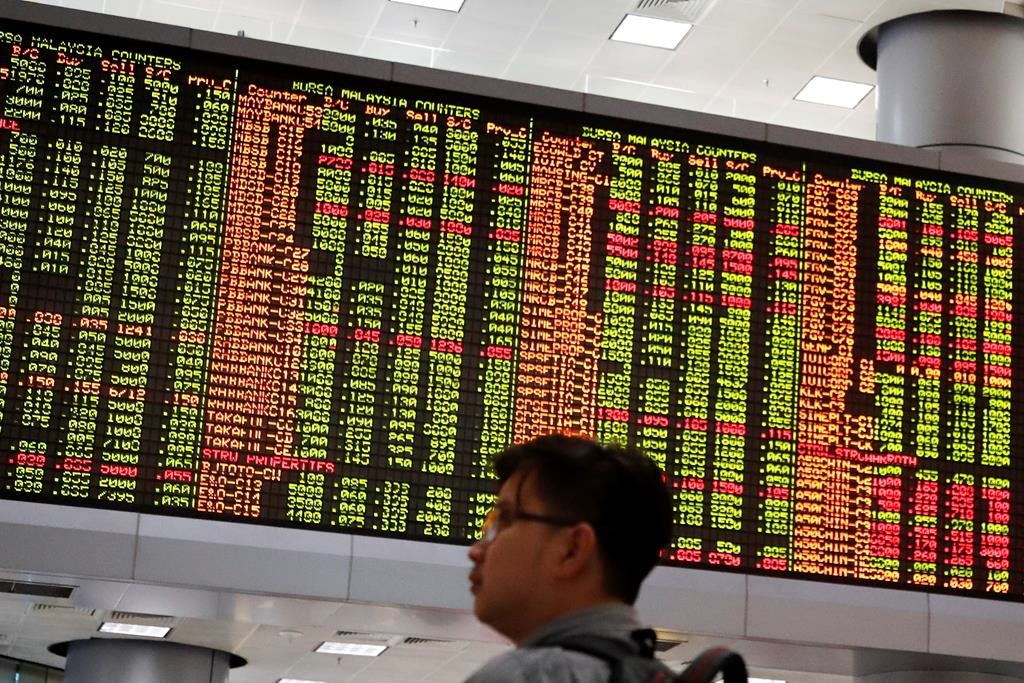 Visitors stand in front of private stock trading boards at a private stock market gallery in Kuala Lumpur, Malaysia, Wednesday, May 8, 2019. The Dow Jones Industrial Average tumbled more than 470 points Tuesday amid a broad sell-off on Wall Street.