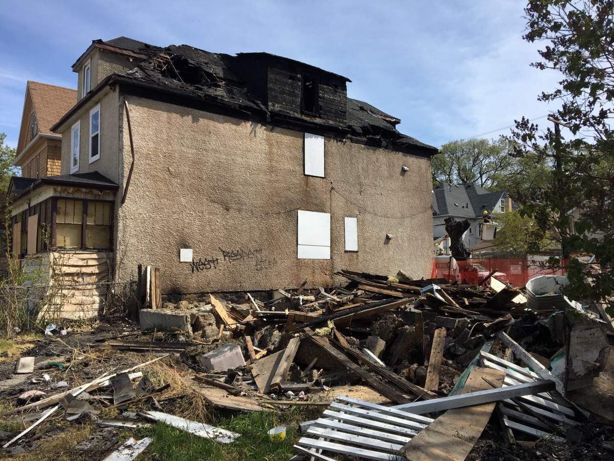 Nicki Hunter’s home is shown next to the demolished abandoned home that went up in flames Sunday morning.